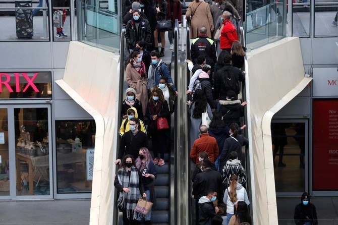 Shoppers use the escalators at the Westfield Forum des Halles in Paris on January 30, 2021, a day before the closing of large shopping centres, following new sanitary measures decided by the Government to curb the spread of Covid-19. (AFP)