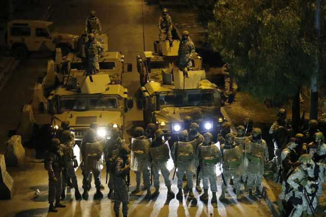 Lebanese soldiers prepare to move protesters from streets during a protest in Tripoli, Lebanon, on Jan. 29, 2021 gainst deteriorating living conditions and strict coronavirus lockdown measures. (AP Photo/Hussein Malla)