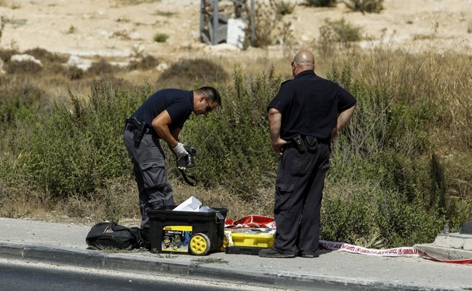 Israeli forensic policemen inspect the place where a 24-year-old Palestinian attempted to stab Israeli soldiers and was shot dead by security forces, at the Gush Etzion junction, July 28, 2017. (File/AFP)
