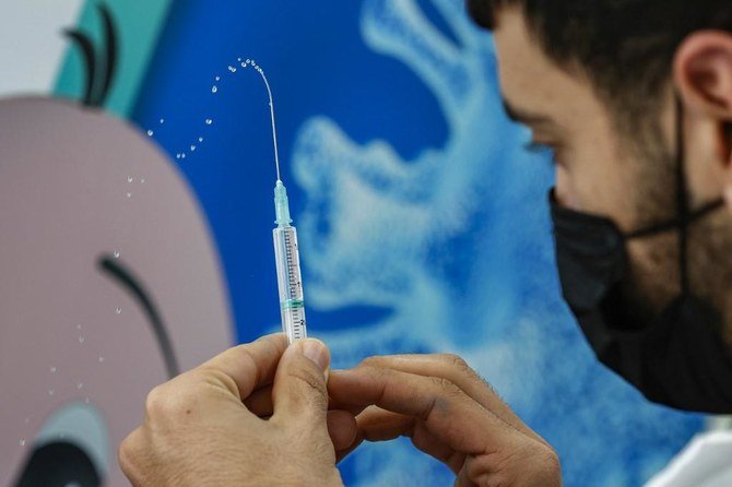 A health worker prepares a dose of the Pfizer-BioNtech COVID-19 coronavirus vaccine at Clalit Health Services, in Israel’s Mediterranean coastal city of Tel Aviv on Jan. 23, 2021. (File/AFP)