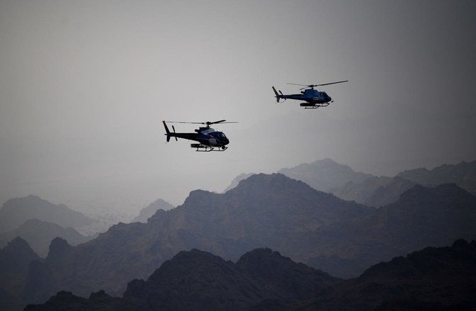 An aerial picture shows helicopters flying overhead during stage 7 of the Dakar Rally 2021. (AFP)