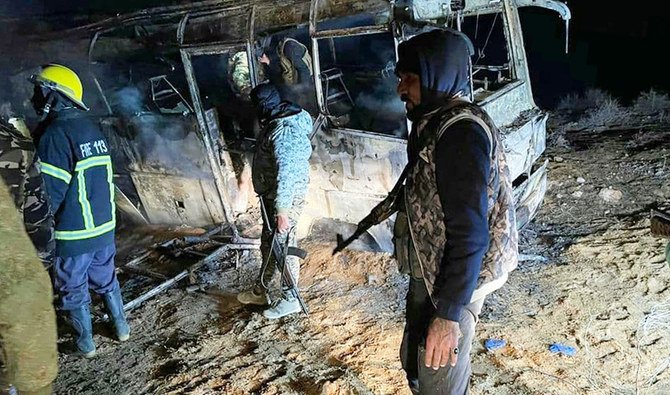 The scene of an attack targeting a bus transporting regime soldiers as they traveled home for holidays in the eastern province of Deir Ezzor. (AFP)