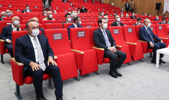 Turkey's President Recep Tayyip Erdogan (right), Foreign Minister Mevlut Cavusoglu (left), and Finance Minister Berat Albayrak (center), wearing face masks to protect against the spread of coronavirus, attend an inauguration ceremony, in Istanbul, Saturday, July 4, 2020. (AP)