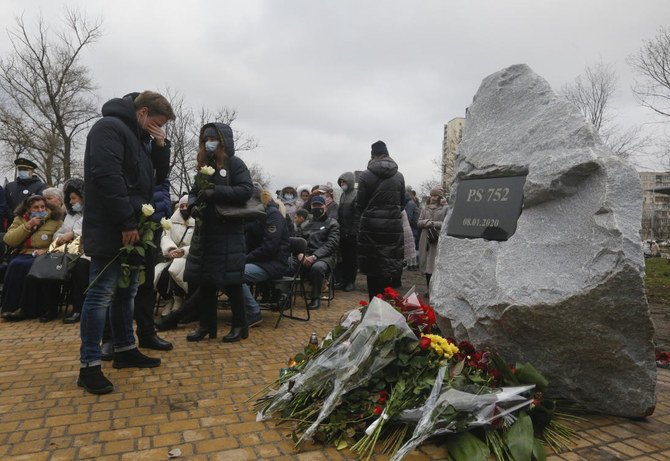Relatives lay flowers to a memorial in Kyiv, Ukraine, Friday, Jan. 8, 2021, for the victims of a Ukrainian 737-800 plane crash on the outskirts of Tehran. (AP)