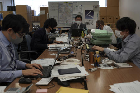 Staff at the local office for COVID-19 vaccination preparation work at Tokyo's Sumida ward office Friday, Jan. 22, 2021. Japan is accelerating preparations for COVID-19 vaccinations in hopes of starting them in late February, but uncertainty is growing as the country faces vaccine-shy public, slow approval process and bureaucratic roadblocks, casting a doubt if Tokyo Olympic this summer is possible. (AP)