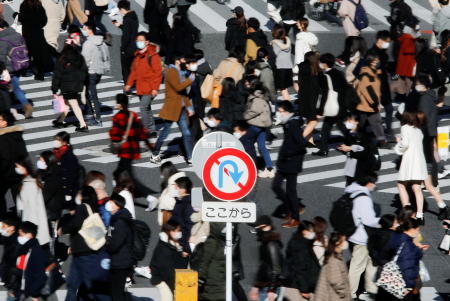 Passersby wearing protective face masks walk at Shibuya crossing after the government declared the second state of emergency for the capital and some prefectures, amid coronavirus disease (COVID-19) outbreak, in Tokyo, Japan. (Reuters)