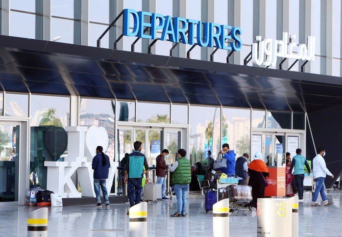 Passengers wait at the departure gate at Kuwait international airport in Kuwait City on January 3, 2021, as the country reopens the airport after a 12-day closure to stem the spread of the COVID-19 pandemic. (AFP)