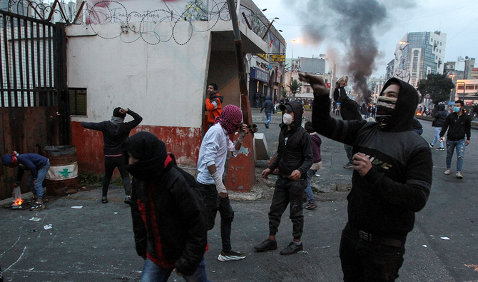 Demonstrators throw stones at the government Serail building during a protest against the lockdown and worsening economic conditions, amid the spread of the coronavirus disease (COVID-19), in Tripoli, Lebanon January 26, 2021. (Reuters)