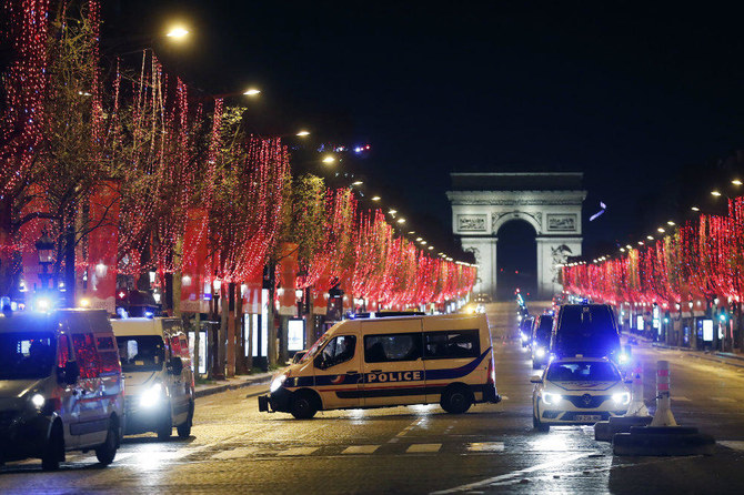 Police vans are parked on the Champs Elysees avenue during the New Year's Eve in Paris on Dec. 31, 2020. (AP)