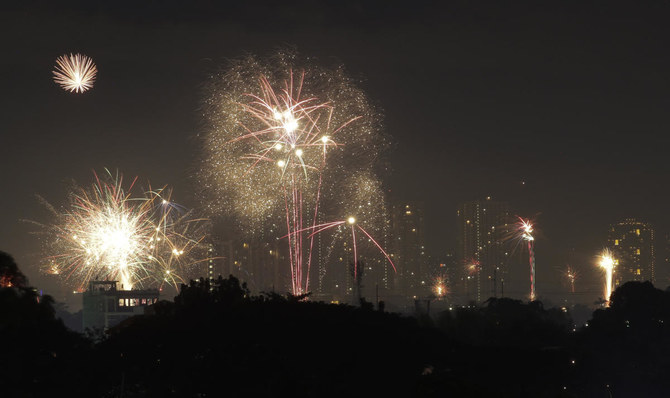Fireworks light up the sky during subdued New Year's celebrations as the government banned mass gatherings to prevent the spread of the coronavirus, early Friday, Jan. 1, 2021, in Quezon city, Philippines. (AP)