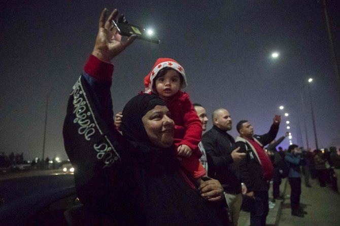 People watch fireworks explode over the River Nile in the Egyptian capital Cairo during New Year's Eve celebrations on December 31, 2020. (AFP)