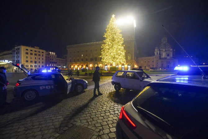 Police officers stop a car in Piazza Venezia, usually a popular spot for New Year's Eve celebrations, in Rome, on Jan. 1, 2020. (AP)