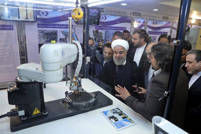 Iranian President Hassan Rouhani listens to explanations on new nuclear achievements in Tehran in this April 2018 file photo (Iranian Presidency Office via AP)