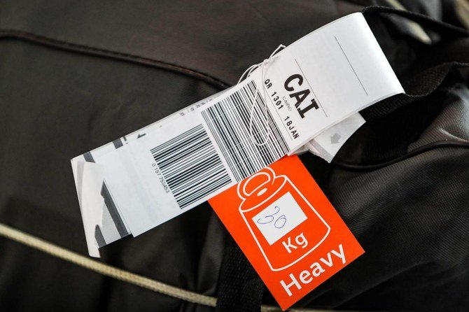 This picture taken on January 18, 2021 shows a luggage tag on a suitcase being transported on the first flight between Doha and Cairo after the reopening of Egyptian airspace to Qatari flights following a thaw in relations between Doha and a Saudi-led bloc, at Hamad International Airport near the Qatari capital Doha. (AFP)