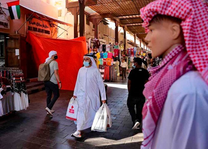 Emiratis shop at the Dubai grand market, in the Gulf city of Dubai, on Jan. 6, 2021. (AFP)