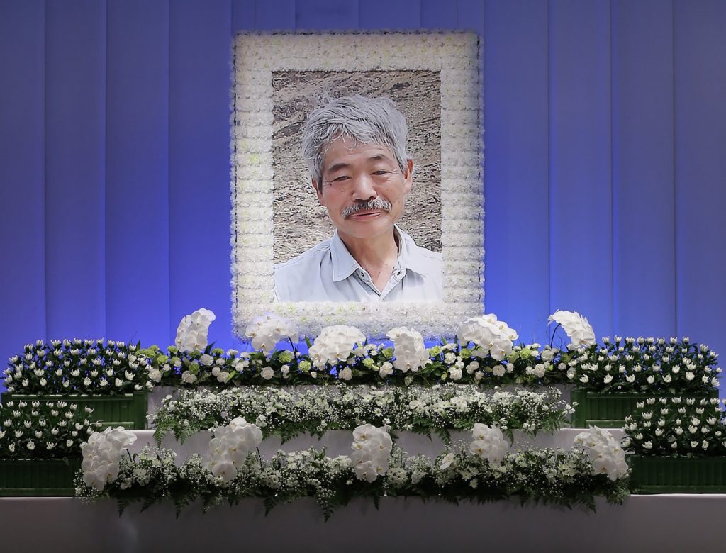 This picture shows a portrait of late Japanese doctor Tetsu Nakamura, who was shot to death in Afghanistan after decades of his earnest support for the country, and his coffin at a funeral parlour in Fukuoka on December 11, 2019. (AFP)