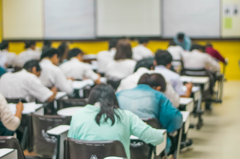 General photo of students taking an exam. (Shutterstock)