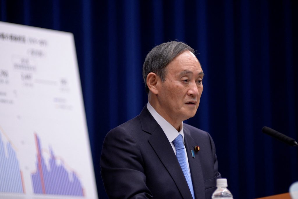Japan's Prime Minister Yoshihide Suga speaks during a press conference in Tokyo on February 2, 2021, to announce the government has approved a month-long extension of its coronavirus state of emergency less than six months before the pandemic-postponed Olympic Games open. (AFP)