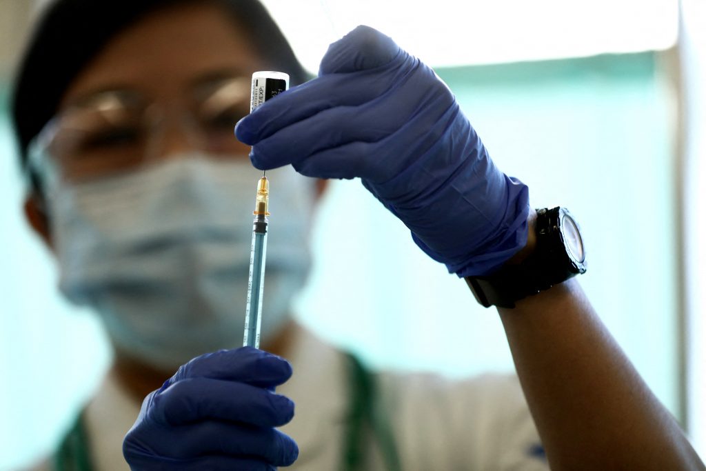 A medical worker fills a syringe with a dose of the Pfizer-BioNTech COVID-19 vaccine as the country launches its inoculation campaign at the Tokyo Medical Center in Tokyo on February 17, 2021. (AFP)