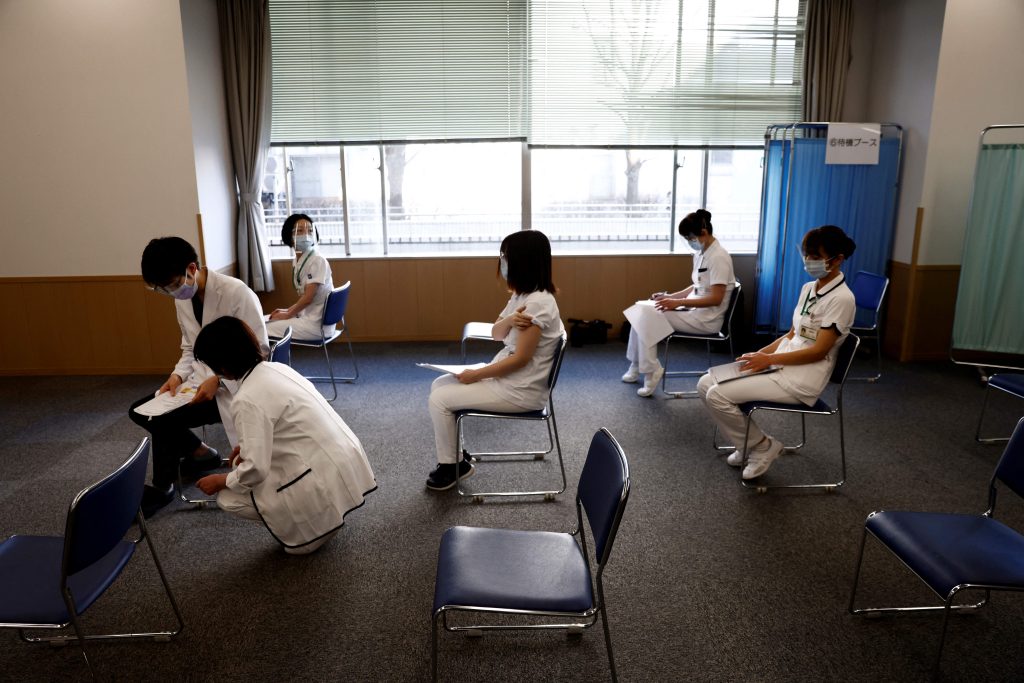 Medical workers wait for consultations after receiving a dose of the COVID-19 vaccine as the country launches its inoculation campaign at the Tokyo Medical Center in Tokyo on February 17, 2021. (AFP)