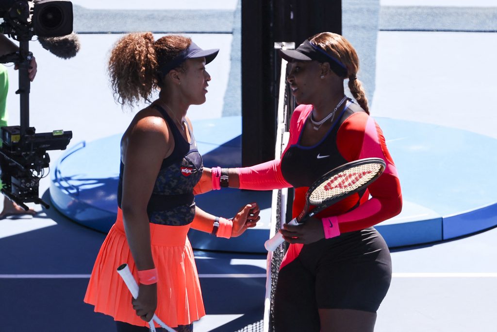 Japan's Naomi Osaka (L) greets Serena Williams of the US at the end of their women's singles semi-final match on day eleven of the Australian Open tennis tournament in Melbourne on February 18, 2021. (AFP)