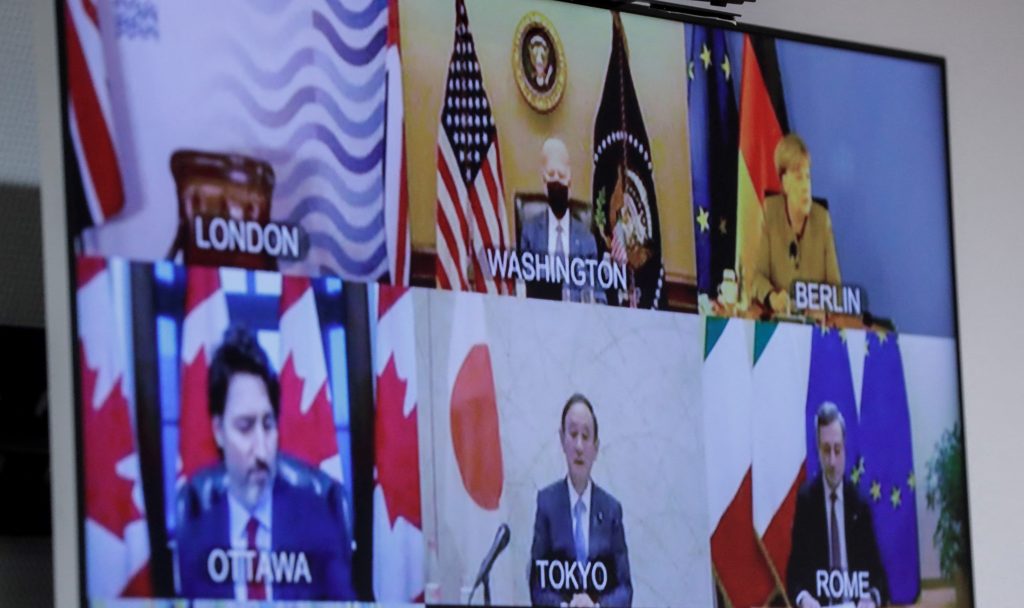 G7 head of states are seen on a screen as European Commission President and European Council President take part in the Online G7 Summit from European council headquarters in Brussels, on February 19, 2021.(AFP)