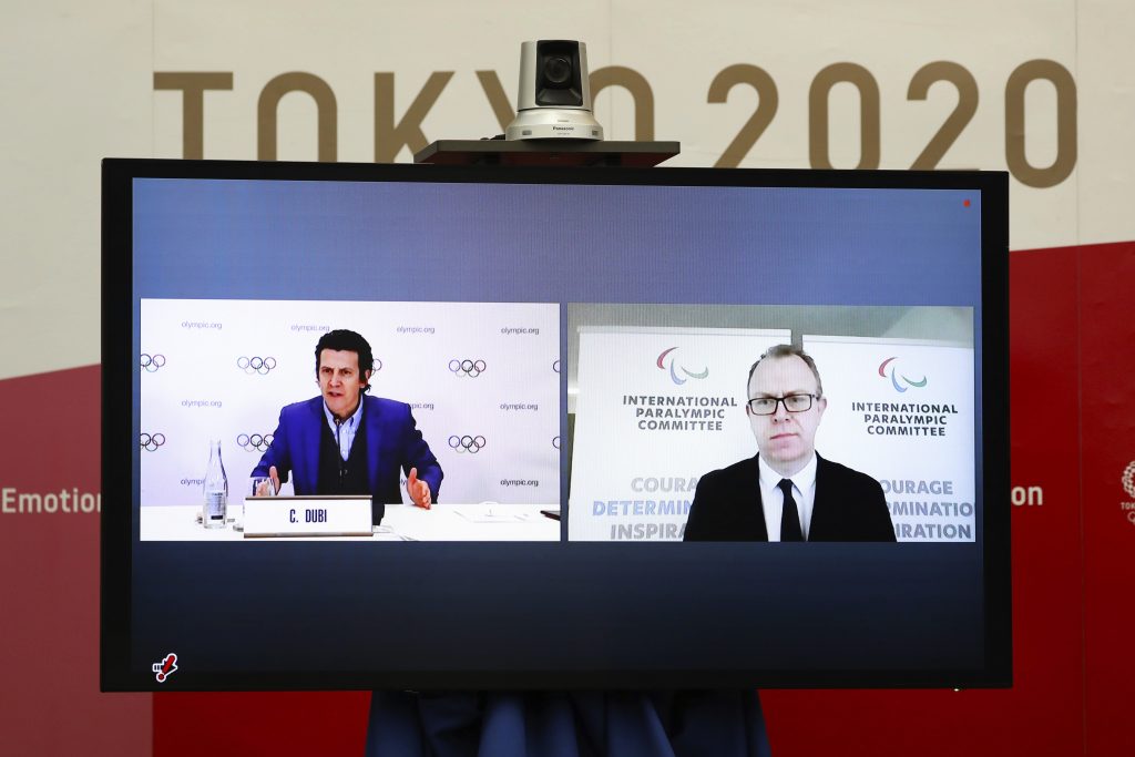 Christophe Dubi, Olympic Games Executive Director for the International Olympic Committee (IOC), left, and Craig Spence, Chief Brand and Communications Officer for the International Paralympic Committee (IPC), join other representatives from the Tokyo Organizing Committee of the Olympic and Paralympic Games (Tokyo 2020) at a Joint press briefing in Tokyo on Wednesday, Feb. 3, 2021. (AP)