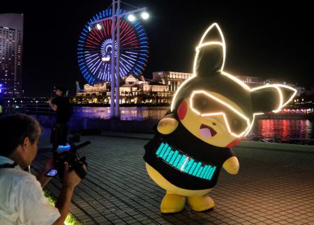 In this file photo taken on August 8, 2019 a performer dressed as Pikachu, the popular animation Pokemon series character, participates in a light performance during the Pikachu parade in Yokohama. (AFP)
