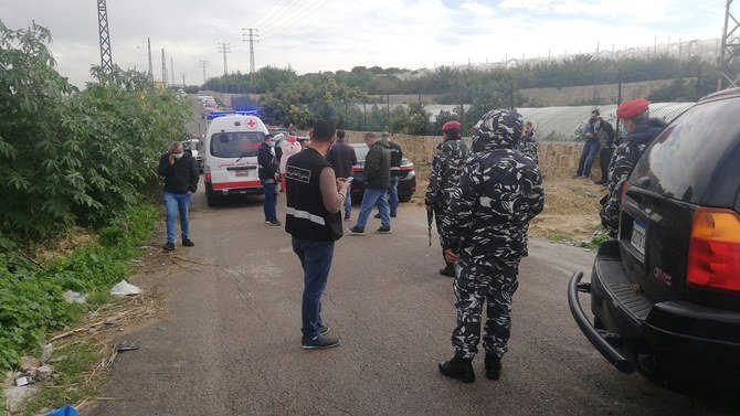 Police gather at the side where the body of anti-Hezbollah journalist and activist Luqman Salim was found in his car. (Reuters)