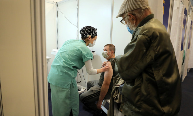 A man receives a vaccination at Rabin Square in Tel Aviv, Israel, on New Year’s Eve. (Reuters)