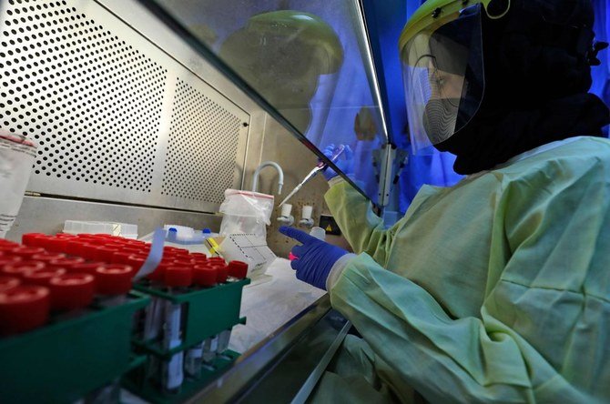 A medical worker tests samples at a Palestinian Health Ministry testing lab for COVID-19 coronavirus disease in the West Bank city of Ramallah on February 2, 2021.(AFP)