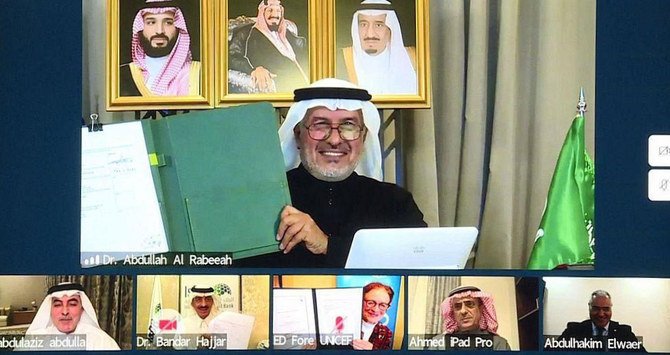 KSrelief chief Dr. Abdullah Al-Rabeeah shows the deal’s document during an online ceremony on Tuesday. (SPA)
