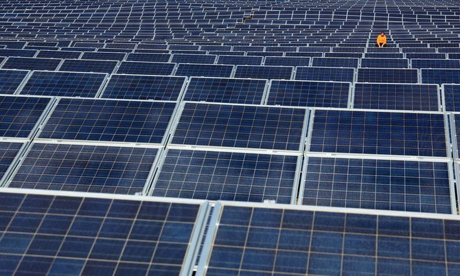 Saudi Arabia’s Ministry of Energy announces it is prepared to begin working with small solar PV systems. Pictured a maintenance worker examining solar panels at Norsol solar energy company in Villaldemiro, northern Spain. (File/AFP)