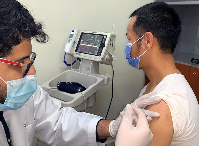 A man is vaccinated against COVID-19 in Dubai on Feb. 8, 2021. Key transport hub Dubai began today mass vaccination of public transport workers, with the Gulf emirate aiming to remain open to international tourism despite surge in cases. (AFP)