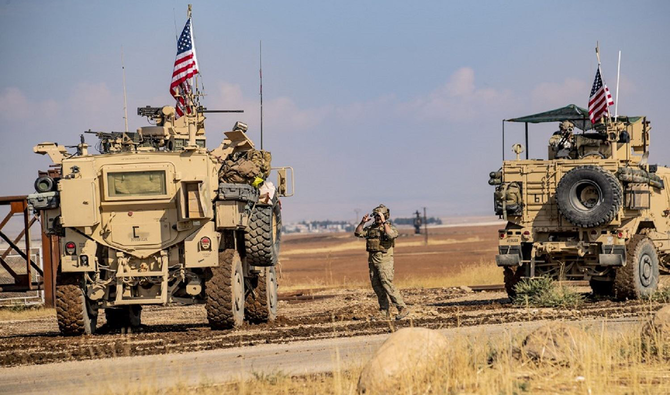 A convoy of US military vehicles drive through the Syrian northeastern town of Qahtaniyah on the border with Turkey. (AFP/File)