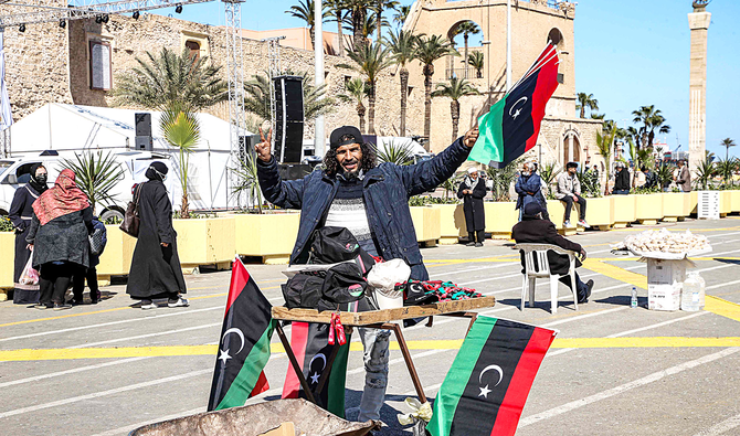 A hawker at Martyrs’ Square in Tripoli on Tuesday sells Libyan flags. (AFP)