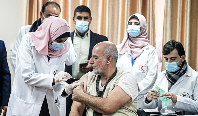 Former Palestinian Health Minister Jawad Tibi receives a dose of the Russian Sputnik V coronavirus vaccine in Gaza City on Monday. (AFP)