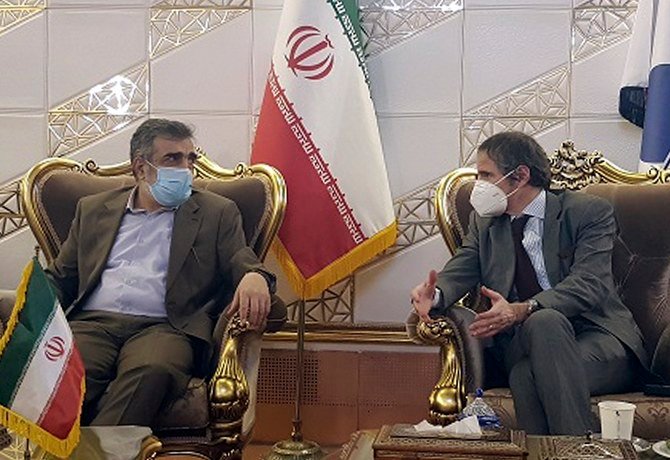 Director General of International Atomic Energy Agency, Rafael Mariano Grossi (R), speaks with spokesman of Iran’s atomic agency Behrouz Kamalvandi upon his arrival at Tehran’s Imam Khomeini airport, Iran. (File/Atomic Energy Organization of Iran via AP)