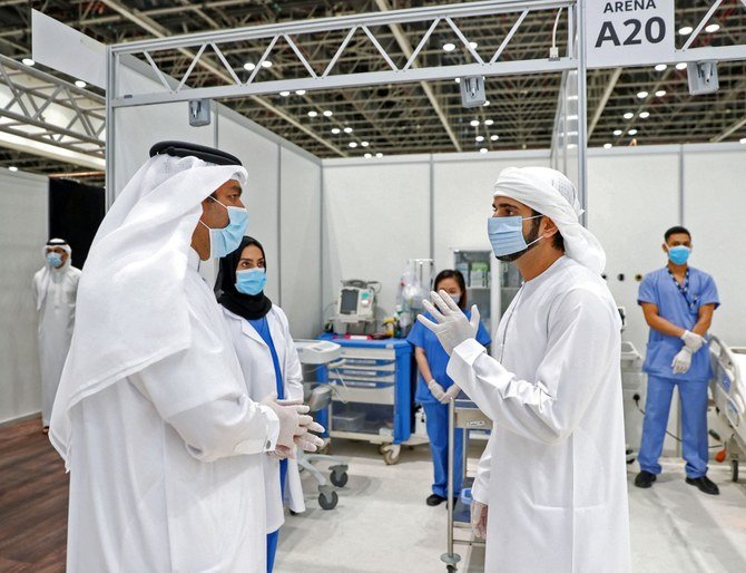 Handout image by the media office of Dubai's Crown Prince Sheikh Hamdan bin Mohammed Al-Maktoum on April 18, 2020, shows him (R) inspecting a field hospital at the Dubai World Trade Center during the inauguration ceremony. (File/AFP)