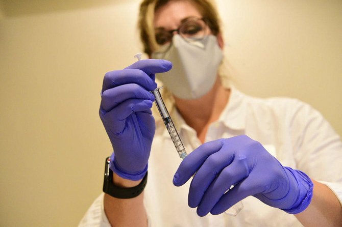 A pharmacist prepares to give a Johnson & Johnson experimental, single-shot COVID-19 vaccine in this September 2020 photo. (Johnson & Johnson via AP, File)