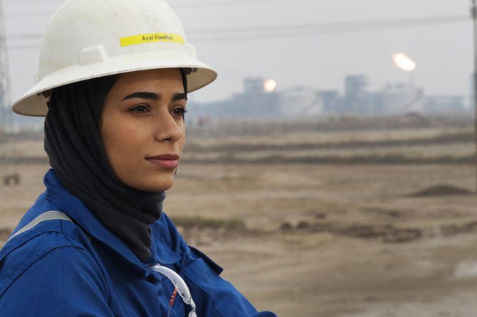 Ayat Rawthan, a petrochemical engineer, poses for a photo near an oil field outside Basra, Iraq, Tuesday, Feb. 5, 2021. (AP)