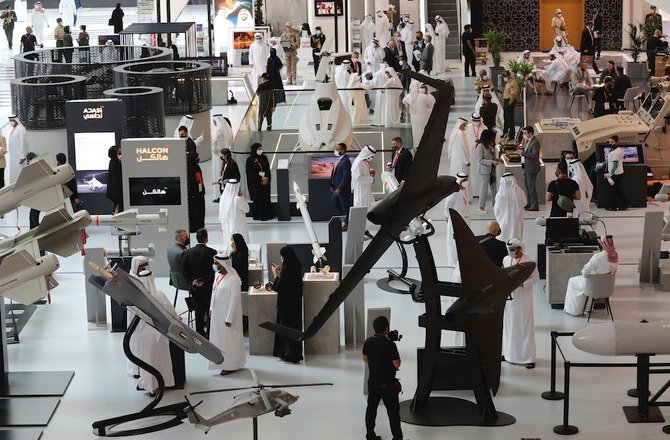 People visit military equipment on display during the opening day of the International Defence Exhibition & Conference, IDEX, in Abu Dhabi, United Arab Emirates, Sunday, Feb. 21, 2021. (AP)