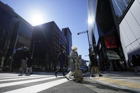 People wearing protective masks to help curb the spread of the coronavirus walk along a pedestrian crossing Thursday, Feb. 4, 2021, in Tokyo. (AP)
