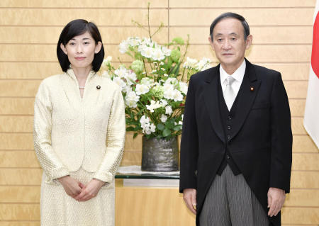 New Olympic Minister Tamayo Marukawa (left) poses with Japanese Prime Minister Yoshihide Suga at the prime minister's official residence in Tokyo, Thursday, Feb. 18, 2021. (Kyodo News via AP)