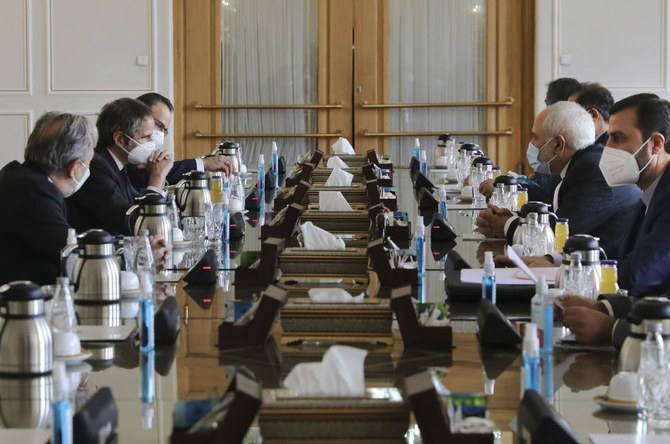 Director General of International Atomic Energy Agency, IAEA, Rafael Mariano Grossi, right, looks towards Iranian Foreign Minister Mohammad Javad Zarif during a meeting, in Tehran, Iran, Sunday, Feb. 21, 2021. (AP Photo)