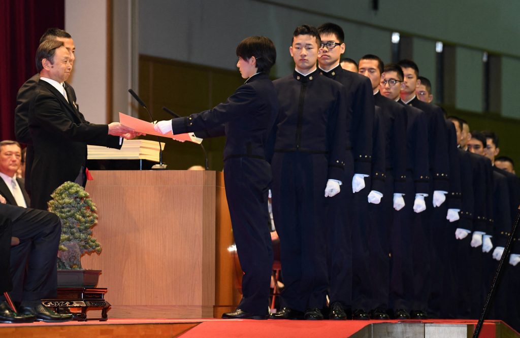 Students receive their diplomas during the graduation ceremony for the National Defense Academy in Yokosuka, Kanagawa prefecture on March 18, 2018. (AFP)