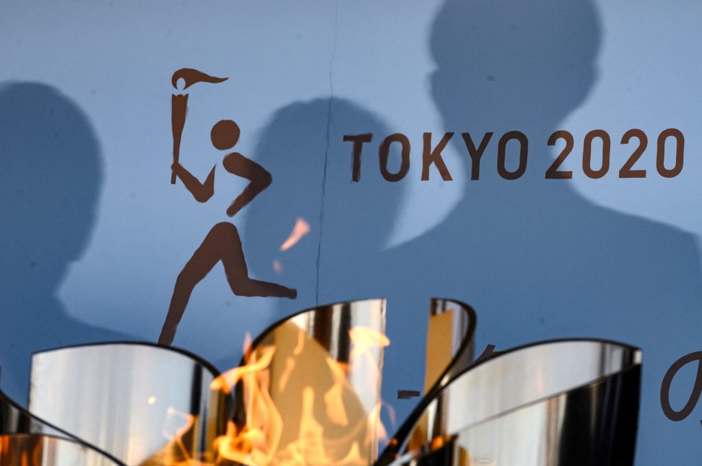 The logo for the Tokyo 2020 torch relay is pictured as the Olympic flame goes on display. (AFP)