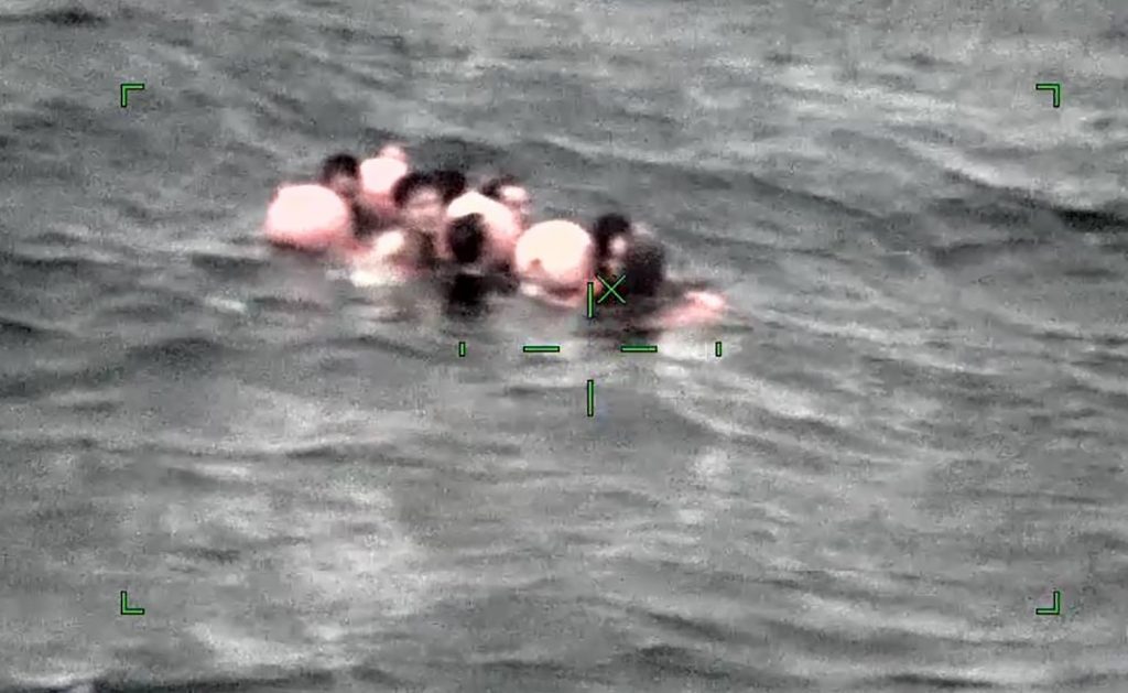 Image taken by camera mounted on aircraft and released by the 11th Regional Japan Coast Guard Headquarters shows crew members of a Chinese fishing boat capsized off Ishigaki Island, Okinawa prefecture, southern Japan, March. 2, 2021. (File photo/The 11th Regional Japan Coast Guard Headquarters via AP) 
