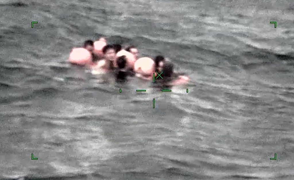 Image taken by camera mounted on aircraft and released by the 11th Regional Japan Coast Guard Headquarters shows crew members of a Chinese fishing boat capsized off Ishigaki Island, Okinawa prefecture, southern Japan, March. 2, 2021. (File photo/The 11th Regional Japan Coast Guard Headquarters via AP)