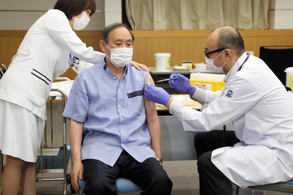Japanese Prime Minister Yoshihide Suga receives his first dose of Pfizer's COVID-19 vaccine at National Center for Global Health and Medicine in Tokyo Tuesday, March 16, 2021. (Kyodo News via AP)